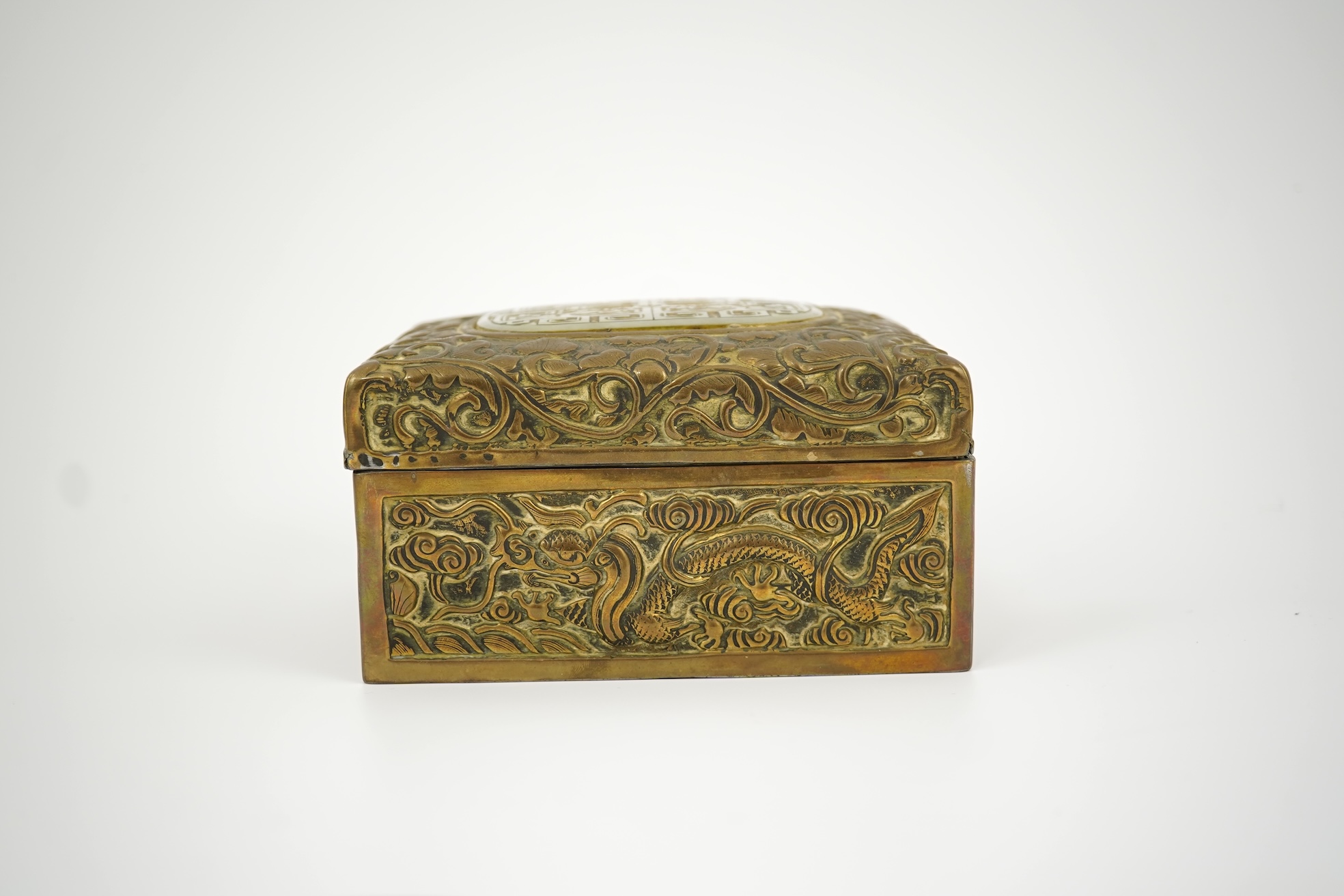 A Chinese brass 'dragon' box, inset with a 17th/18th century jade plaque